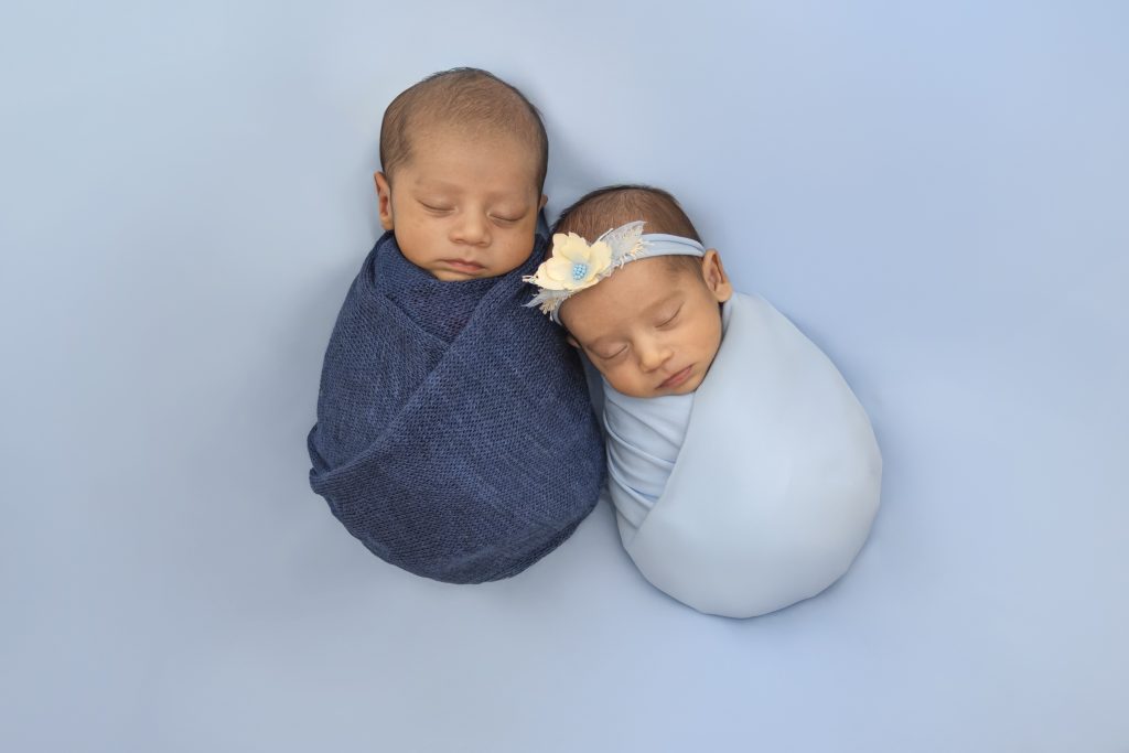 Newborn baby sleeping in a woven basket during a Nook Look studio session
