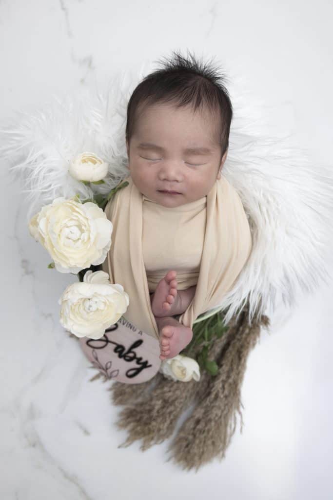 Newborn baby resting on a textured blanket during a Nook Look studio session