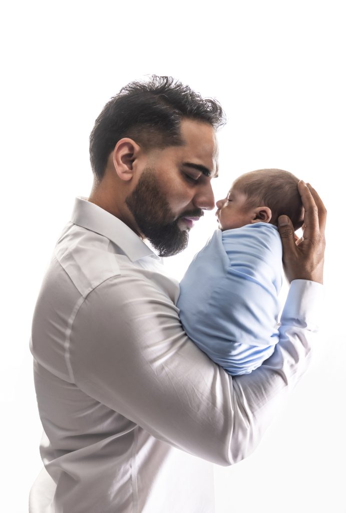 Newborn baby photographed in a cozy studio setup at Nook Look