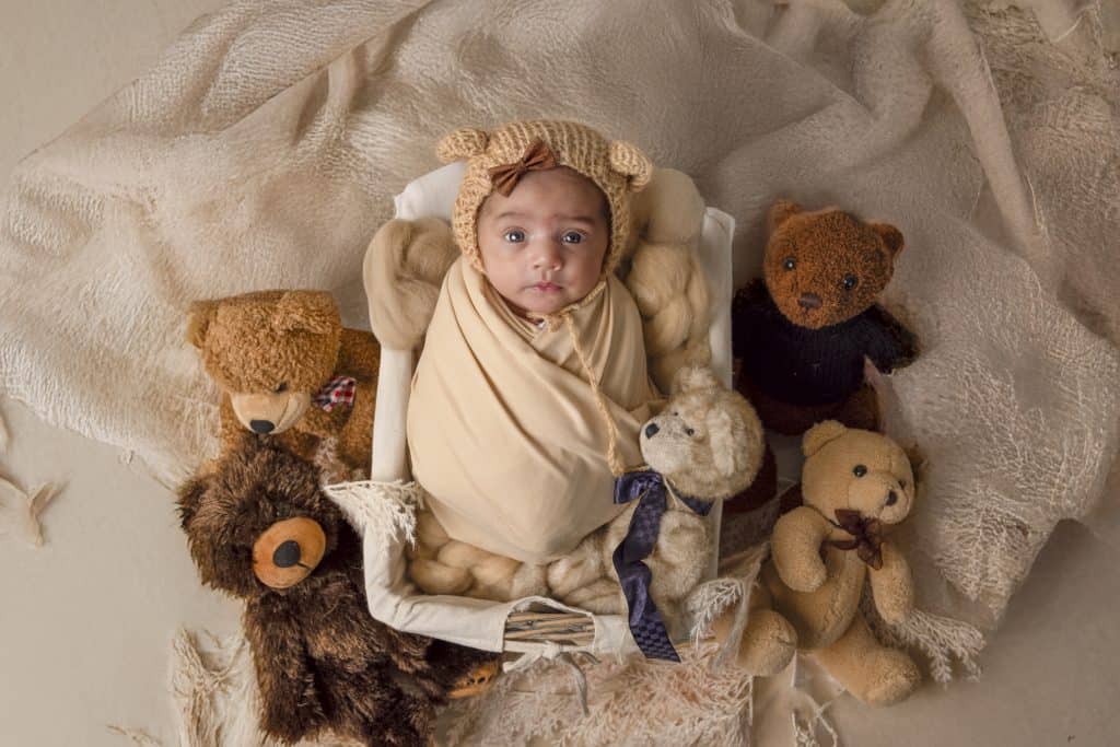 Newborn baby wrapped in a soft swaddle, Nook Look newborn photography session